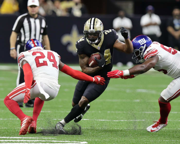 New Orleans Saints running back Dwayne Washington (24) rushes through the tackle of New York Giants cornerback James Bradberry (24). Mandatory Credit: Stephen Lew-USA TODAY Sports